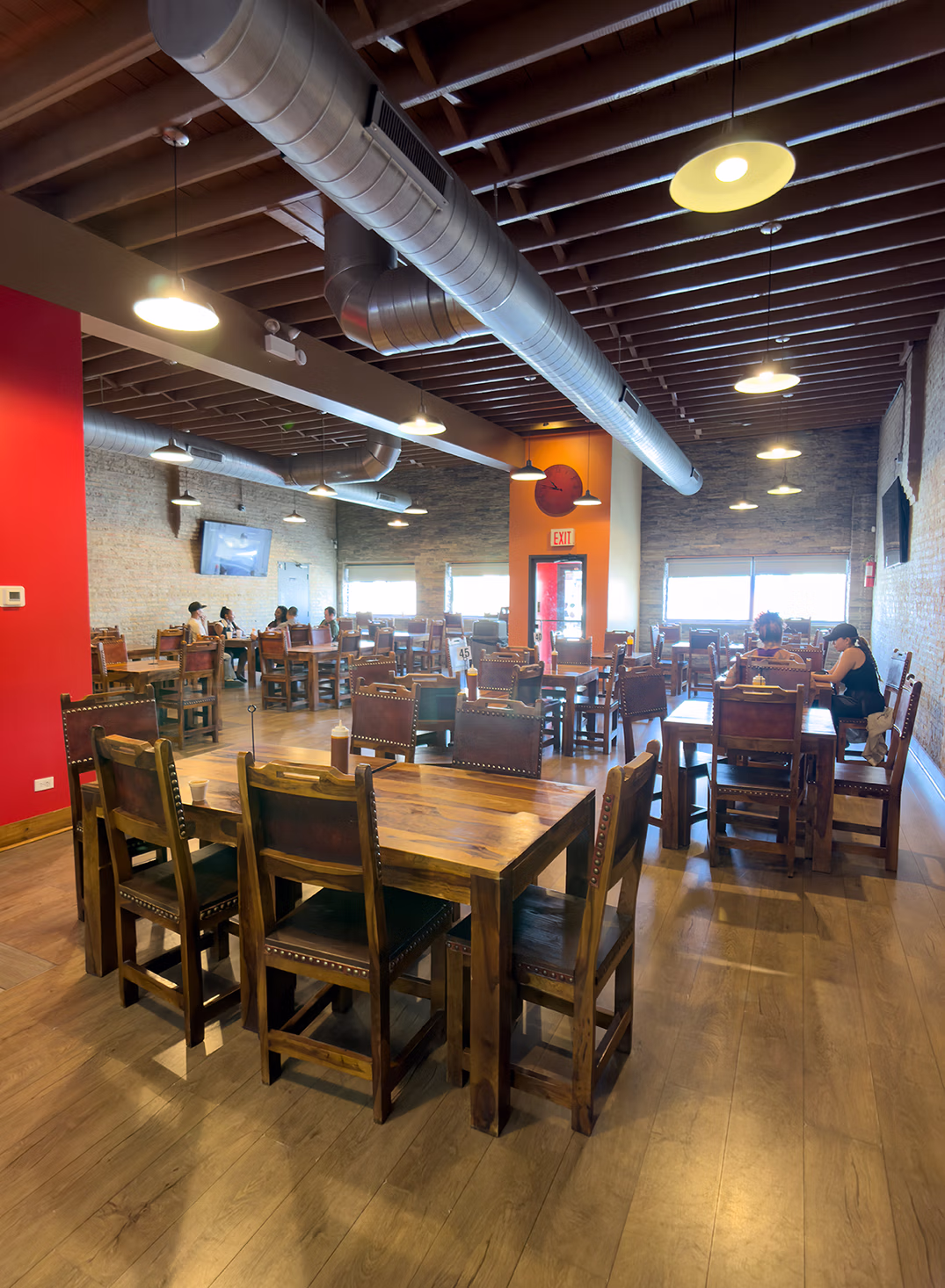 Spacious interior dining room and wooden table seating at El Cubanito in Chicago